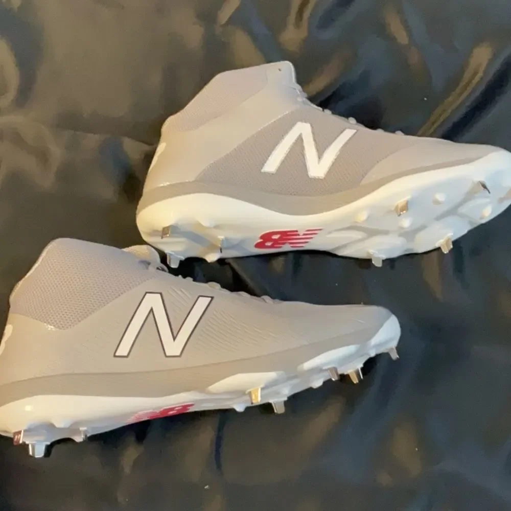 New Balance Gray and White Men's Athletic Cleats.  16 2E Wide